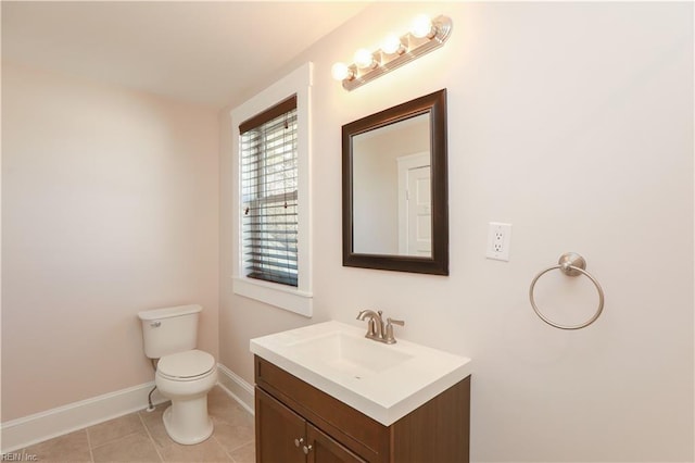 bathroom with tile patterned flooring, vanity, and toilet