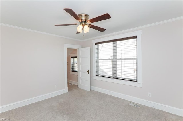 carpeted empty room with ceiling fan and ornamental molding