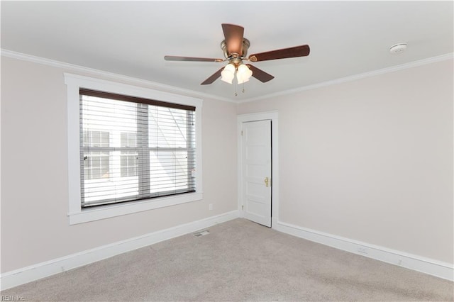 carpeted empty room with ceiling fan and crown molding