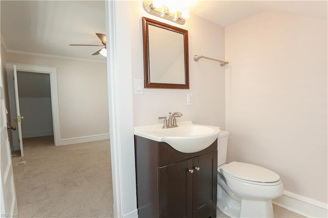 bathroom with ceiling fan, vanity, ornamental molding, and toilet