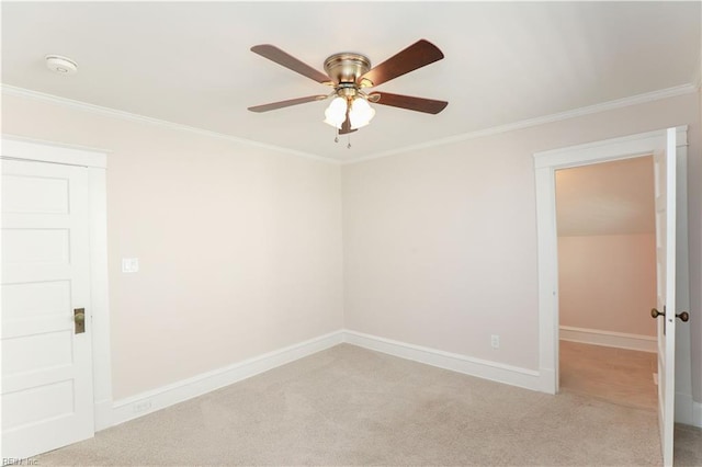 carpeted empty room with ceiling fan and crown molding