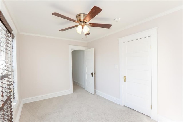 unfurnished bedroom featuring ceiling fan, light colored carpet, and ornamental molding