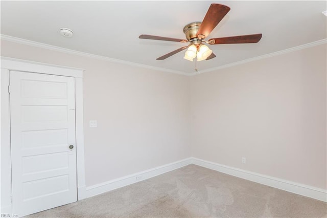 unfurnished room featuring light colored carpet, ceiling fan, and ornamental molding