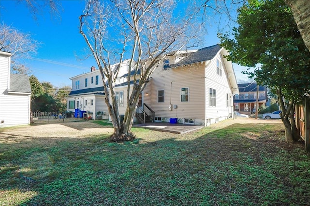 back of property featuring a patio area and a yard