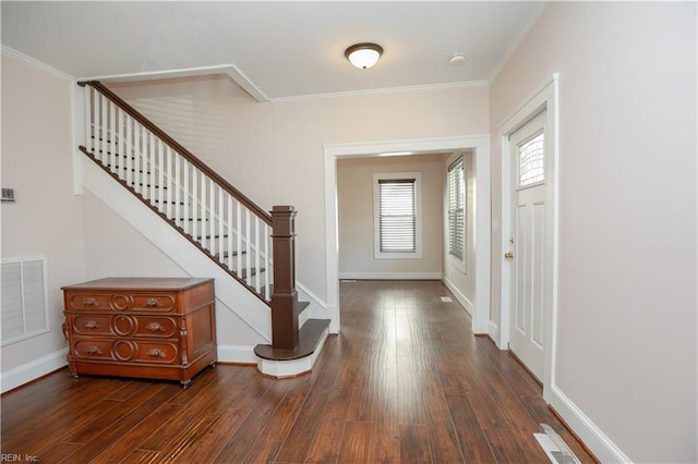 foyer featuring dark hardwood / wood-style floors and ornamental molding