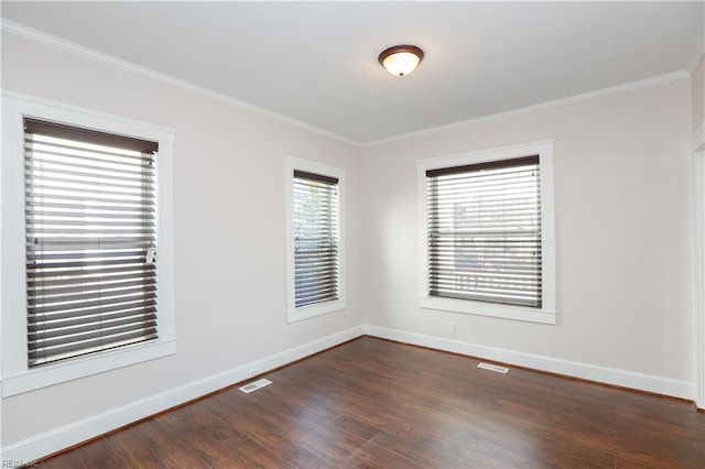 unfurnished room featuring ornamental molding and dark wood-type flooring