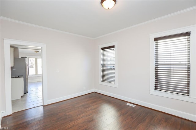 unfurnished room featuring crown molding and dark wood-type flooring