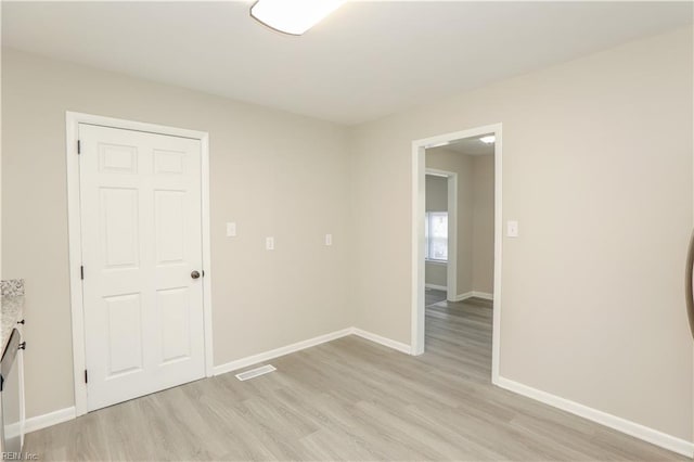 spare room featuring light hardwood / wood-style flooring