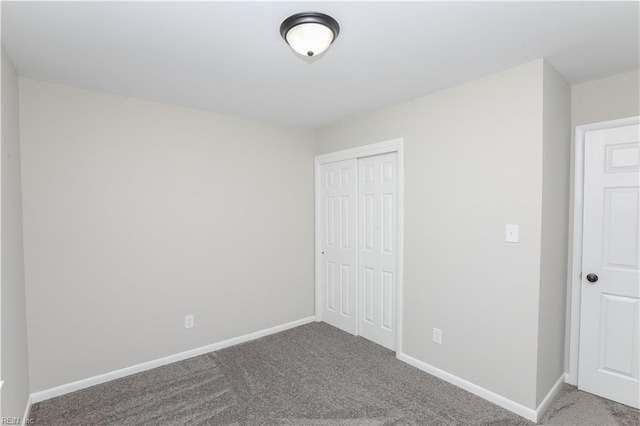 unfurnished bedroom with a closet and carpet