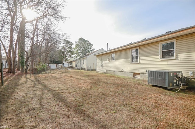 exterior space featuring a lawn and cooling unit