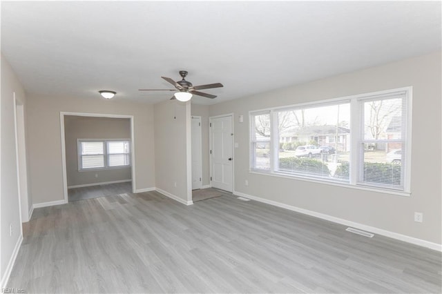 unfurnished living room featuring ceiling fan and light hardwood / wood-style floors