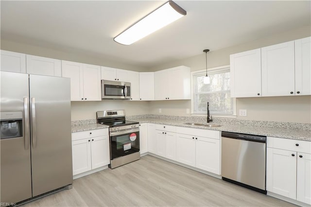 kitchen with sink, white cabinetry, and stainless steel appliances