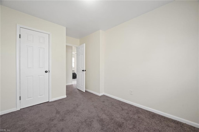 unfurnished bedroom featuring dark carpet