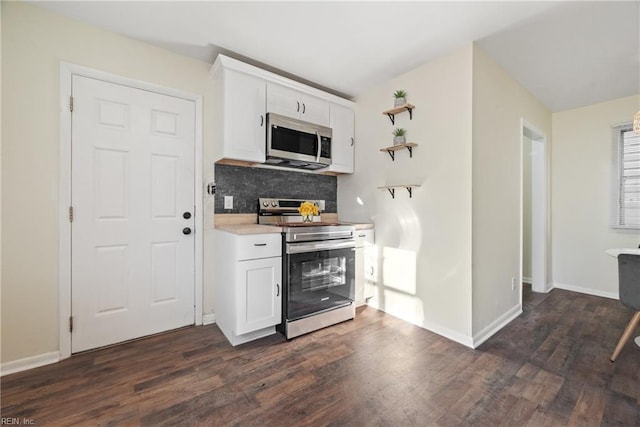 kitchen with decorative backsplash, dark hardwood / wood-style flooring, stainless steel appliances, and white cabinetry