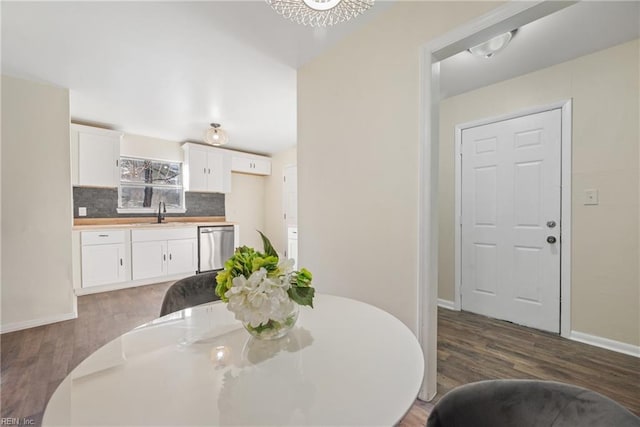 dining room featuring dark hardwood / wood-style flooring and sink