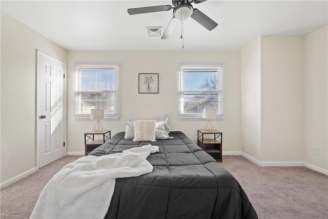 carpeted bedroom featuring multiple windows and ceiling fan