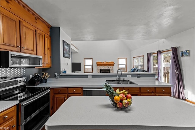 kitchen with appliances with stainless steel finishes, a center island, and sink