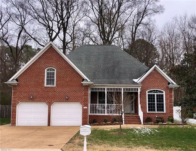 view of front facade with a front yard, a porch, and a garage