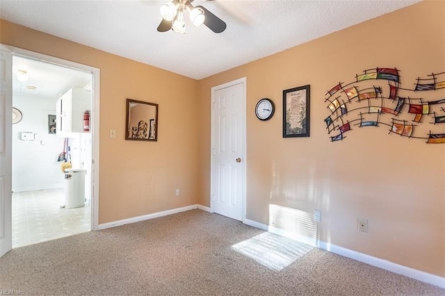 spare room with carpet floors and ceiling fan