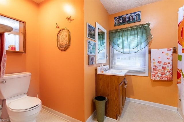 bathroom with vanity, a textured ceiling, and toilet