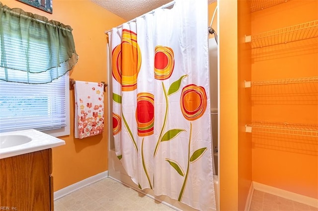 bathroom with vanity, a textured ceiling, and a shower with shower curtain