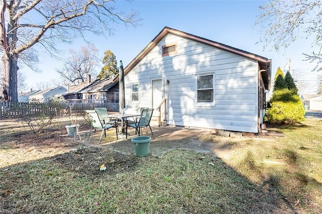 rear view of house with a yard and a patio