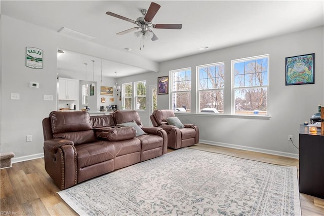 living room with ceiling fan and light hardwood / wood-style floors