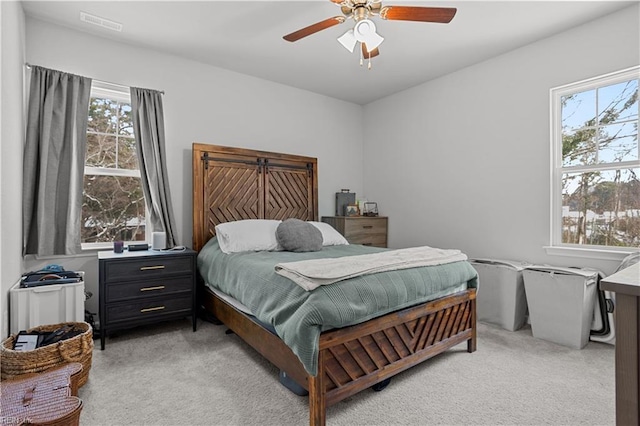 bedroom featuring ceiling fan and light carpet