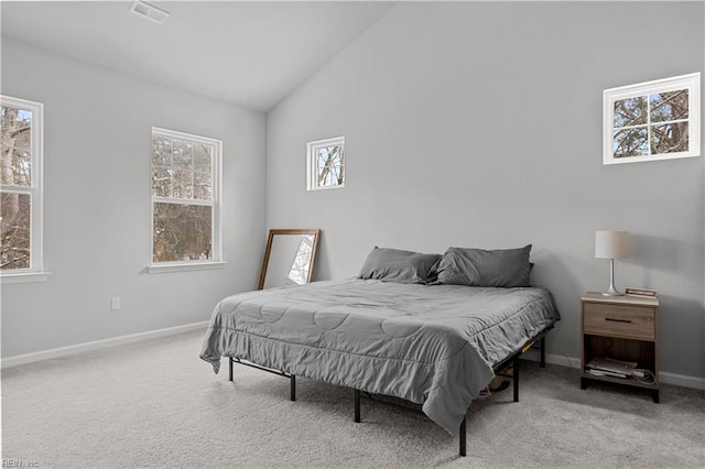 bedroom featuring light carpet and vaulted ceiling