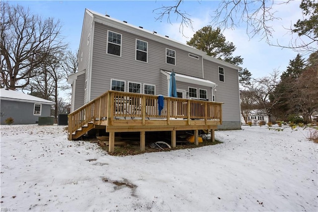 snow covered property with a wooden deck