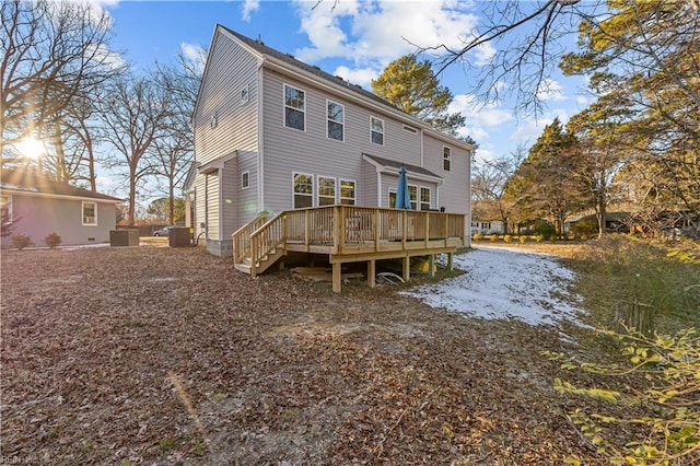 back of house featuring central AC unit and a wooden deck