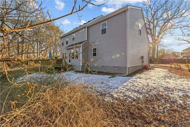 rear view of property featuring a deck