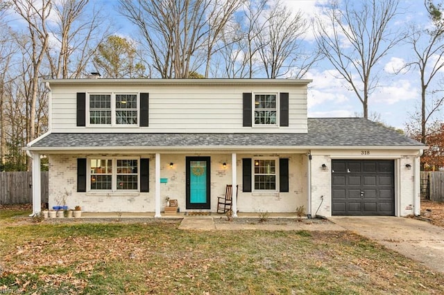 view of front property with a front yard, a garage, and a porch