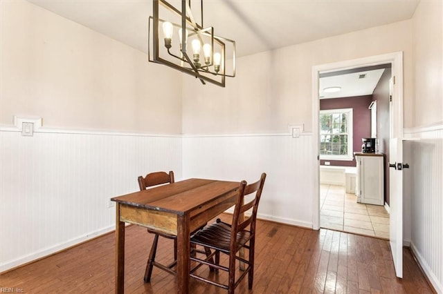 dining space featuring a notable chandelier and hardwood / wood-style flooring