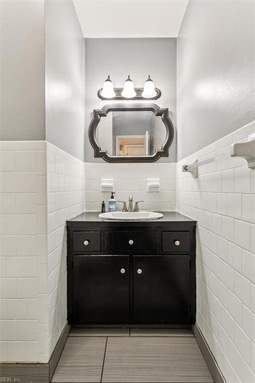 bathroom with tile walls and vanity