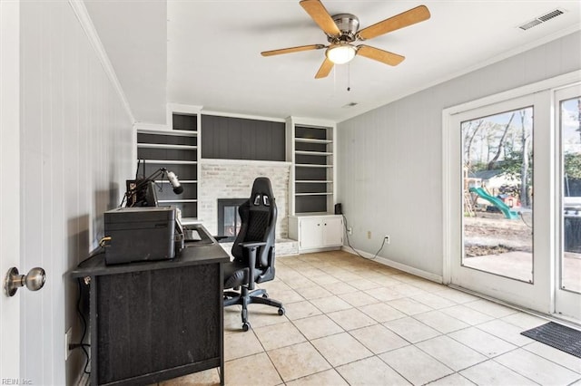 tiled office featuring ceiling fan, built in shelves, and ornamental molding