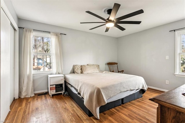 bedroom with ceiling fan, a closet, and hardwood / wood-style floors