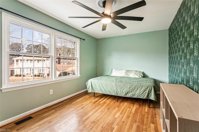 bedroom with ceiling fan and light wood-type flooring