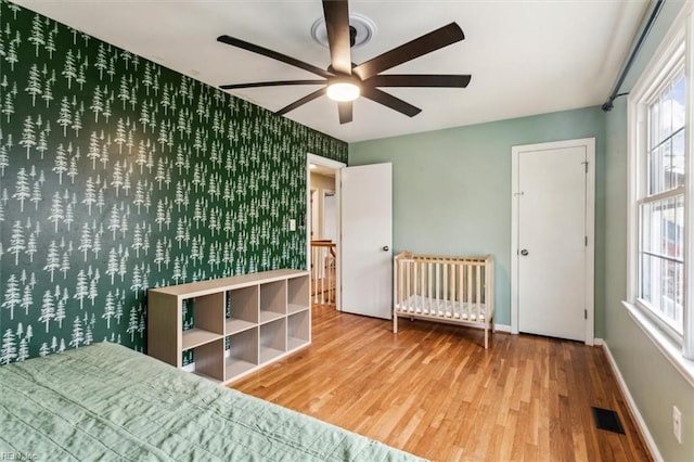 bedroom with ceiling fan and wood-type flooring