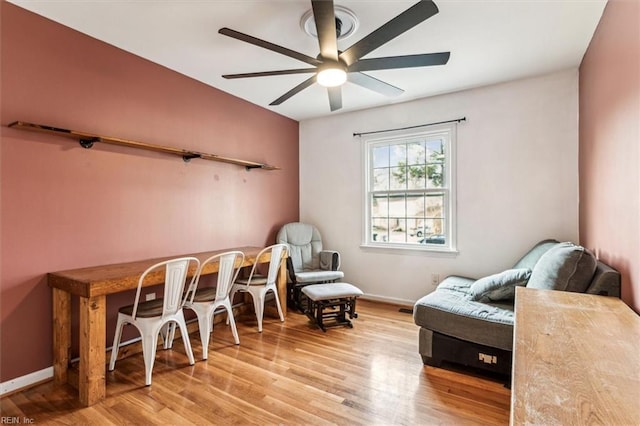 living area with ceiling fan and light hardwood / wood-style flooring