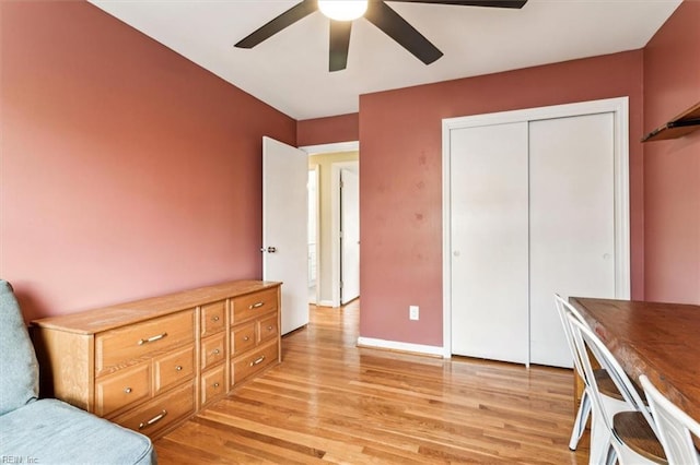 interior space featuring ceiling fan, a closet, and light hardwood / wood-style floors