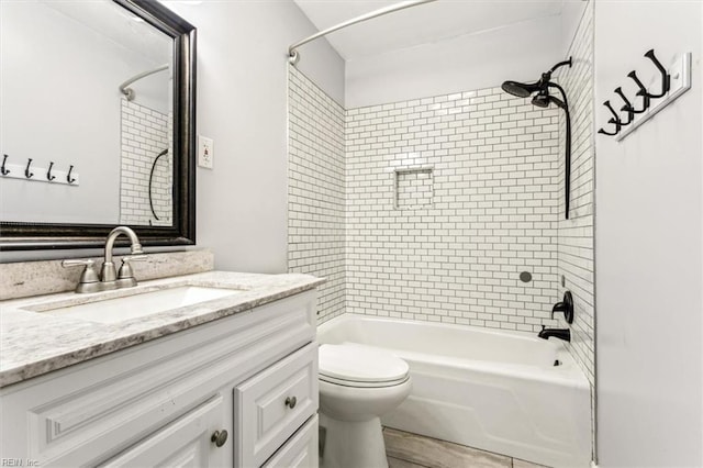 full bathroom with toilet, vanity, and tiled shower / bath combo