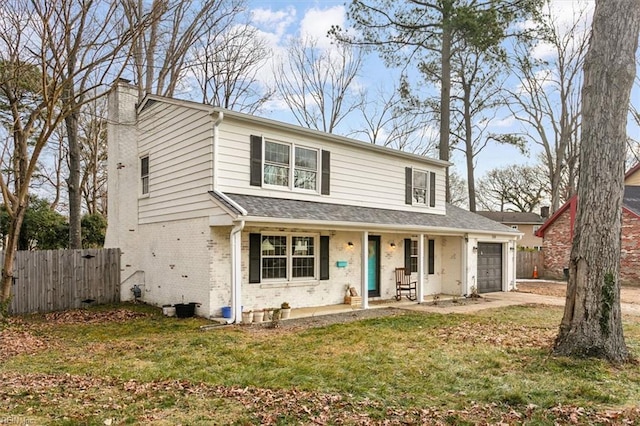 front of property featuring a garage, a front yard, and a porch