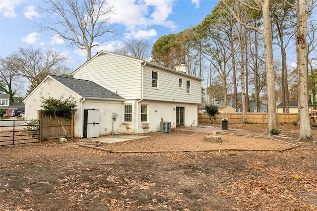 back of house with a patio area, cooling unit, and an outdoor fire pit