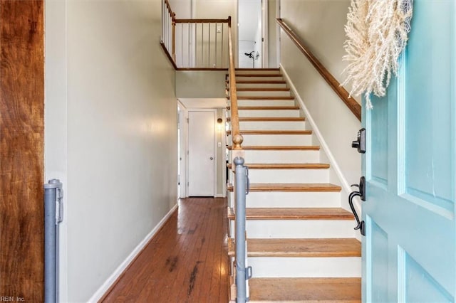 stairs featuring hardwood / wood-style flooring