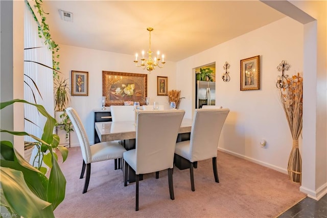 carpeted dining space with a notable chandelier