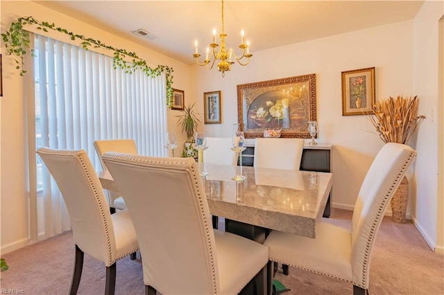 dining space featuring a notable chandelier and light carpet