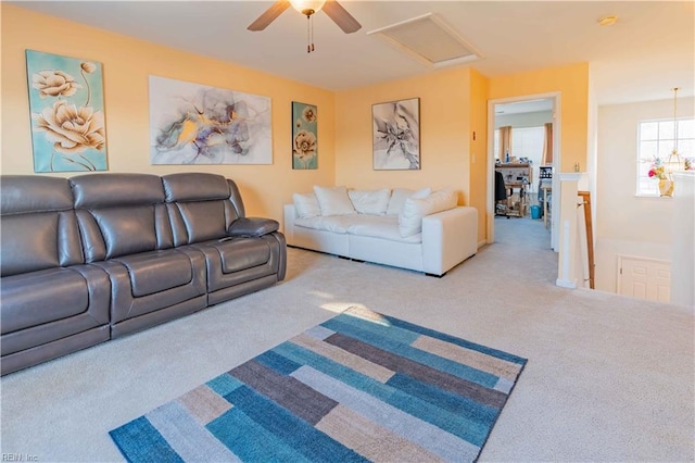 living room featuring carpet flooring and ceiling fan