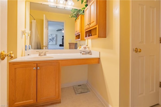 bathroom with vanity, ceiling fan, and walk in shower