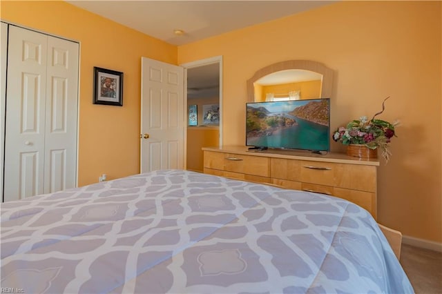 carpeted bedroom with a closet